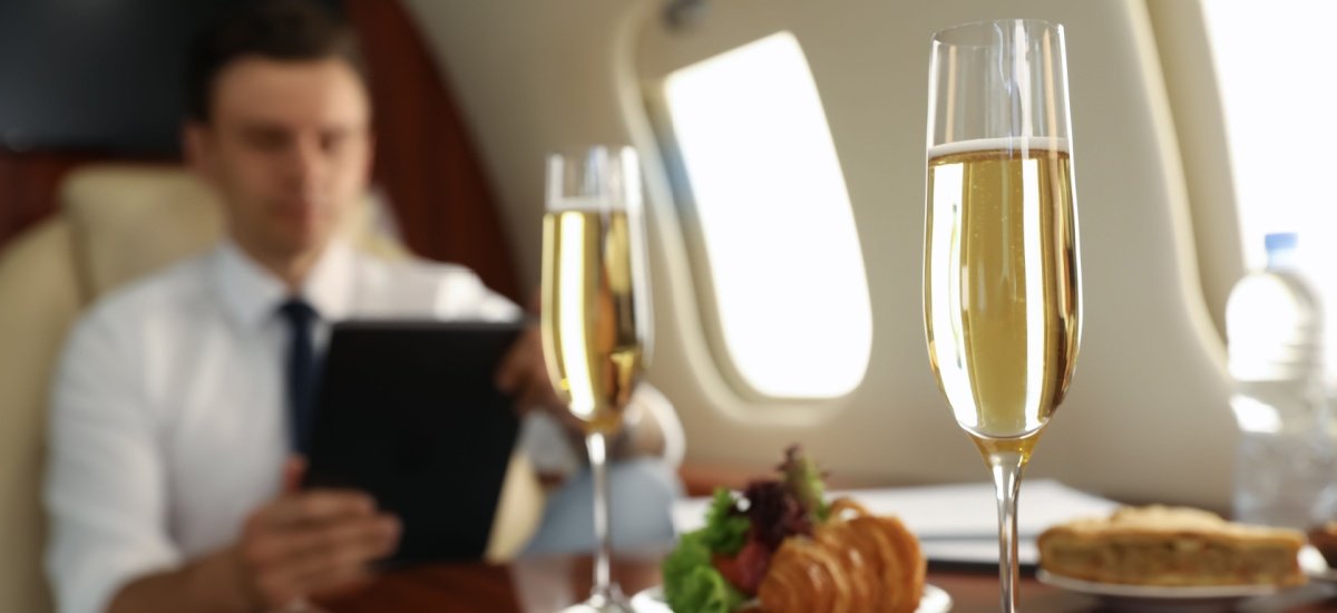 man-sitting-in-business-class-enjoying-champagne